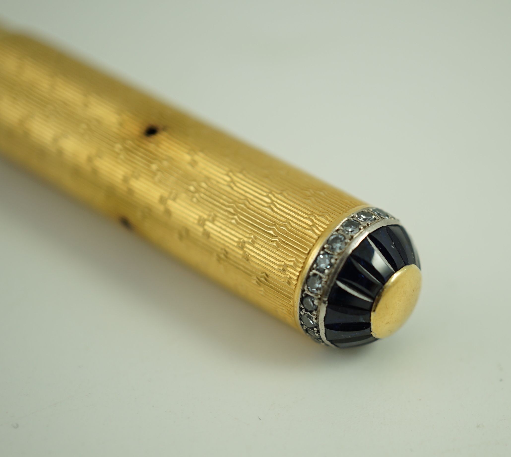 A late 1930's 18ct gold cased and sapphire and diamond set side lever fountain pen, 11cm